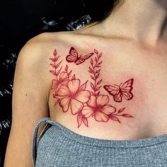 a woman's chest with flowers and butterflies on it