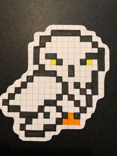 an image of a duck made out of legos on a table with black and white squares