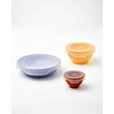 three plastic containers with lids on white background