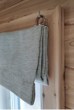 a curtain hanging on the side of a wooden wall