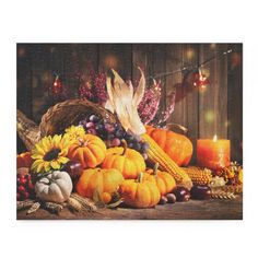 a thanksgiving scene with pumpkins, cornucts and candles