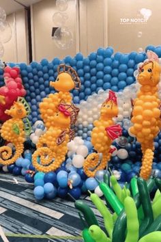 some balloons that are in the shape of seahorses and other animals on a table