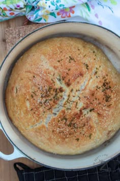 a baked bread in a pan with the words no knead bread on it's side