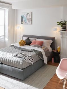 a bedroom with a large bed and white walls