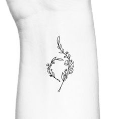 a black and white photo of a flower tattoo