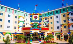 a multicolored building with a clock on it's face and colorful decorations