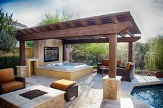 a hot tub sitting next to a patio covered in furniture