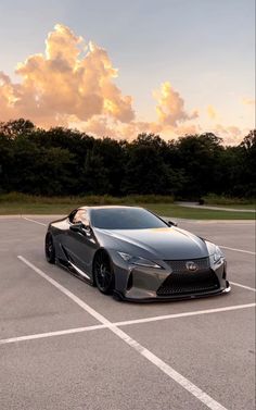 a gray sports car parked in a parking lot