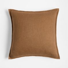 a brown pillow sitting on top of a white wall