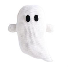 a crocheted white stuffed ghost with black eyes and nose is shown in front of a white background