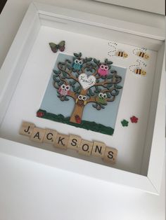 a scrabble frame with an owl family tree