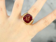 "This large vintage red glass Masonic ring has amazing, yet simply detailed shoulders, rising up from the shank and bending around the corners of the stone. The center is a classic red glass cabochon, inlaid with the gold Masonic symbol, with a nice flat profile. This ring has a substantial feel to it, and makes for a classic Masonic piece! Metal: 14K Yellow Gold Gem: Red Glass Cabochon, Gold Inlaid Masonic Symbol Gem Measures: 16mm x 14mm, Square Cushion Cut Size of Ring: 10 Marks: \"14K\" and Heirloom Red Signet Ring With Polished Finish, Classic Red Signet Ring For Formal Occasions, Classic Red Intaglio Ring, Vintage Red Hallmarked Signet Ring, Antique Red Gemstone Signet Ring, Classic Red Gemstone Signet Ring, Classic Red Ruby Signet Ring, Vintage Red Signet Ring, Red Signet Ring For Formal Occasions