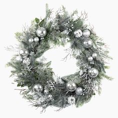 a christmas wreath with silver ornaments and greenery