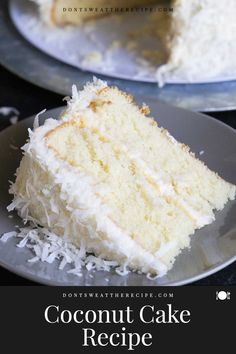 a slice of coconut cake on a plate with the rest of the cake in the background