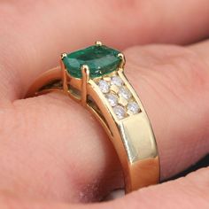 This is part of Chairish’s Fine Jewelry assortment.  Ring in 18 karat yellow gold, eagle head hallmark.  Modern ring, it is decorated with an oval emerald retained with four claws, shouldered on both sides of 2x6 modern brilliant-cut diamonds.  Weight of the emerald : 0,85 carat approximately.  Total weight of the diamonds : approximately 0.21 carat.  Height : 7.9 mm; width : 15.1 mm, thickness : 5.7 mm, width of the ring at the base : 4 mm.  Total weight of the jewel : 7,5 g approximately.  US French Modern, Gold Eagle, Emerald Diamond Ring, Etsy Gold Ring, Eagle Head, Modern Ring, Dior Ring, Yellow Gold Ring, Emerald Diamond