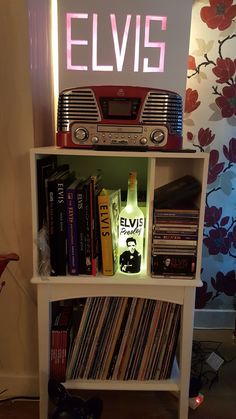 a book shelf with an elvis sign above it