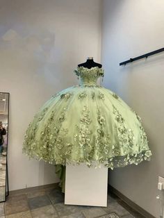 Look like royalty at your special occasion in this stunning off-the-shoulder quinceanera dress. Perfectly crafted with sumptuous, lush sage green quinceanera dress fabric and exquisite 3D florals, it exudes sophistication and class. For an added touch of sophistication, the plus size quince dress sage silhouette offers Sage Green Quinceanera Dresses, Lavender Prom Dress Long, Gown Sleeves, Princess Sweet 16, Quinceanera Themes Dresses