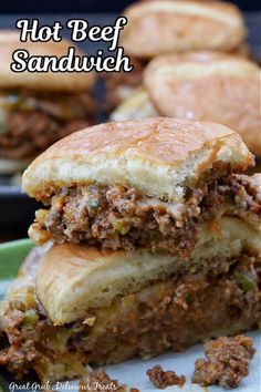 a sandwich cut in half sitting on top of a plate with the words, hot beef sandwich