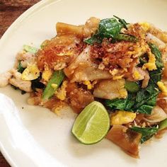 a white plate topped with food on top of a wooden table