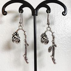 Romantic Grunge Wilted Rose Dangle Earrings   Where my drama kids at?  → Style: dangle earring → Charm:  large silver tone wilted rose with leaves & thorns → Material: charm: metal alloy; nickel-free hook  🚨DM to Bundle & get free shipping! 🚨 ✨earrings handcrafted with love by me ♡  ✨all earrings are brand new & available  ✨4.39 tracked ship; FREE bundle ship on orders of 3+ ✨ALL earrings come with silicone backs!  💌 MESSAGE ME with any questions!   #funkyearrings #cottagecore #fairy #goth #halloween  earrings funky earrings handmade earthy Flower  earrings classic earrings  festival vibes  hippie earrings  silver earrings  plant earrings  floral earrings romantic grunge Fall earrings Rose With Leaves, Wilted Rose, Romantic Grunge, Plant Earrings, Earring Charm, Earrings Funky, Goth Halloween, Fairy Goth, Earrings Classic