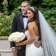 a bride and groom pose for a wedding photo