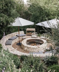 an outdoor fire pit surrounded by umbrellas