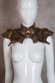 Description Fantasy Empress Shoulder Piece This one of a kind Empress Shoulder Piece is entirely handmade and hand-sculpted, designed to bring a touch of regal elegance to any costume or outfit. It features an antique gold finish with subtle purple and green accents, giving it a unique, mystical appeal. The design is completed with glass 'jade' cabochons for added detail. The 6 handmade horns will be added as a gift. They're only worn once for the shoot pictured. Lightweight and comfortable, the Gold Fantasy Costume Jewelry, Ribbon Tie, Green Accents, Women's Costumes, Gold Finish, Antique Gold, Jade, Violet, Halloween Shopping