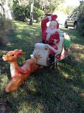 an old fashioned toy sleigh with santa claus riding on it's back