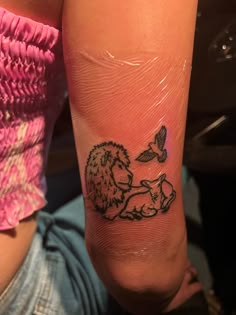 a person with a small tattoo on their leg that has a lion and bird on it