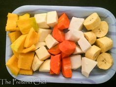 a plastic container filled with cut up fruit