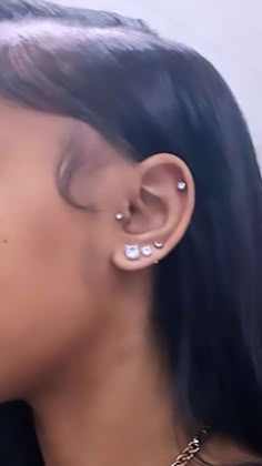 a close up of a person with ear piercings