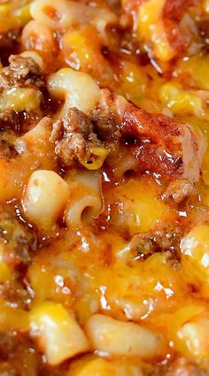 a close up view of some food in a pan with cheese and meat on it