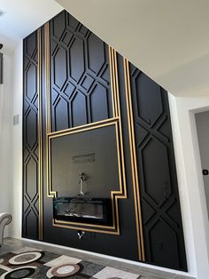 a living room with black walls and gold trim