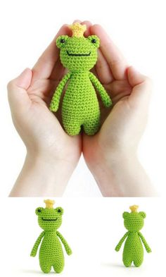 a hand holding a small green frog with a crown on it's head and two smaller ones in their hands