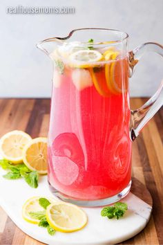 a pitcher filled with water and lemon slices