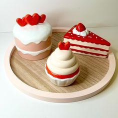 there are three cakes on the wooden tray