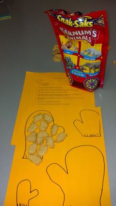 a bag of peanuts sitting on top of a table next to some cut outs and paper