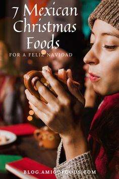 a woman holding a cookie in her hands with the words 7 mexican christmas foods for a feliz navidad