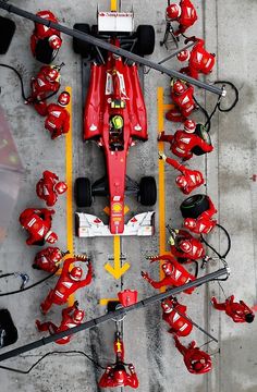 a red race car is parked in a parking lot