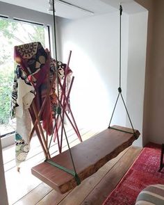 a wooden bench sitting on top of a red rug next to a sliding glass door