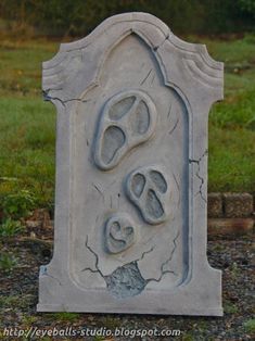 a cement tombstone with two feet sticking out of it's hole in the ground