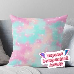 a pink and blue pillow with the words support independent artists on it