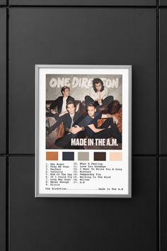 one direction made in the am poster hanging on a wall with black tiles and white frame