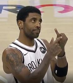 a basketball player holding his hand up in the air