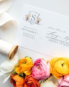 a bouquet of flowers sitting on top of a white envelope