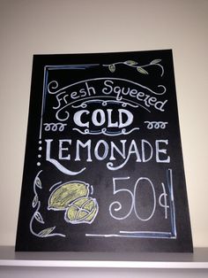 a chalkboard sign that reads fresh squeezed cold lemonade and 50 cents on it