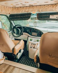 the interior of a vehicle with leather seats and wood trimmings on the floor