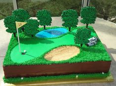 a cake made to look like a golf course with trees and a hole in the middle