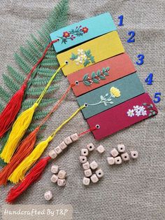 the beads are laid out on the table next to each other with numbers in front of them