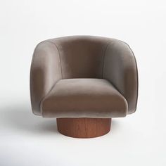 a brown chair sitting on top of a wooden base